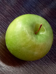 GREEN APPLE ON THE TABLE
