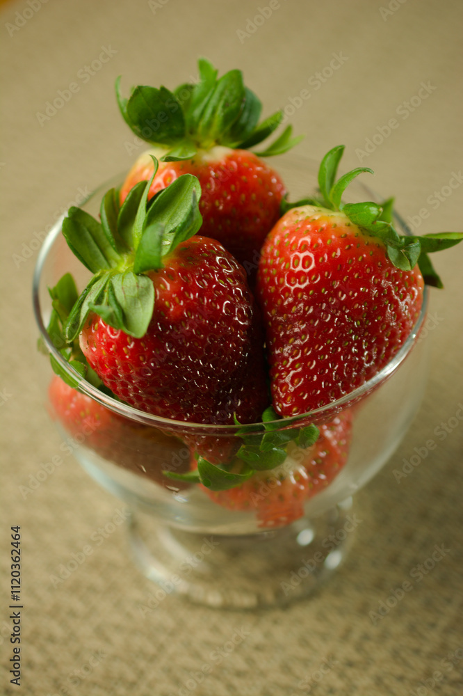 Wall mural Vibrant Strawberries in a Glass Bowl