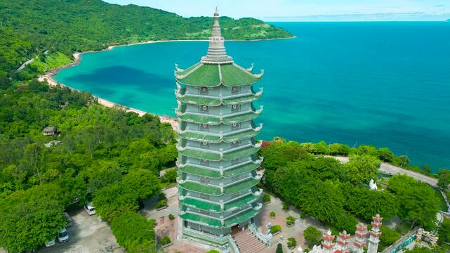 Thap Xa Loi, a serene Buddhist temple, elegantly rises above lush greenery, offering stunning views of the turquoise sea in Da Nang.