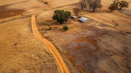 Aerial view of rustic homestead along dusty road rural australia landscape open fields nature preservation