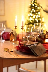 Christmas table setting with stylish dishware and festive decor indoors