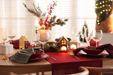 Christmas table setting with stylish dishware and festive decor indoors