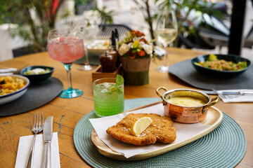 Traditional schnitzel with potato puree and cucumber salad