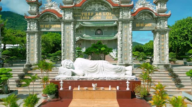 Thap Xa Loi is a serene Buddhist temple in Da Nang featuring an impressive reclining Buddha statue surrounded by lush greenery and meticulously landscaped gardens.