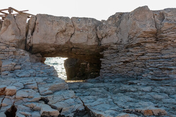Unique natural rock formation with distinctive arch carved out by elements in Kamenjak National Park. Frames a view of calm Adriatic Mediterranean Sea in Premantura, Istria peninsula, Croatia, Europe