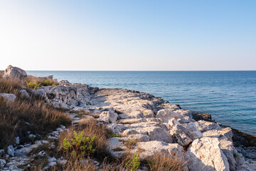 Rocky shoreline along idyllic Cape Kamenjak National Park near Premantura, Istria, Croatia. Calm waters of Adriatic Mediterranean Sea. Summer seaside travel destination. Tranquil peaceful atmosphere