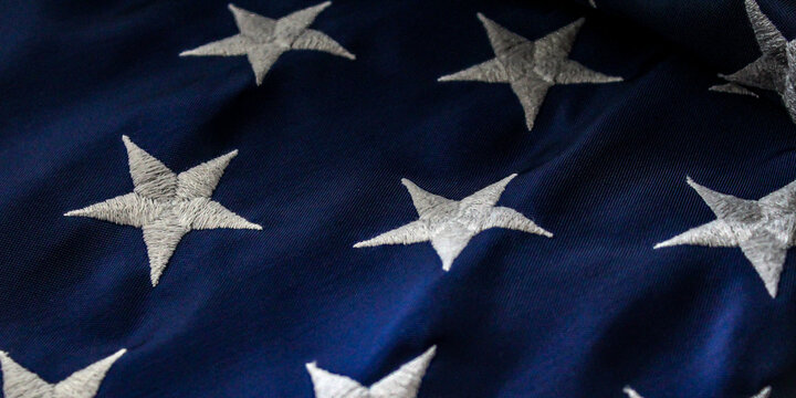 macro close-up of the united states american flag stars fabric textile patriotic background