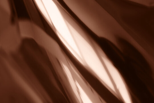 Abstract Metallic Texture with Reflective Bronze Surface and Shadows. Demonstrating color of 2025 year.