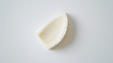 A wedge of creamy white cheese isolated on white