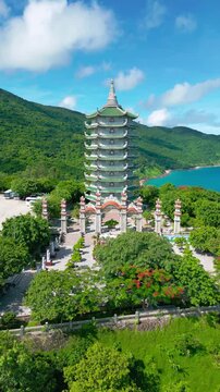 Thap Xa Loi temple stands majestic amid lush greenery and hills in Da Nang, showcasing intricate architecture and serene landscapes typical of Buddhist sites.