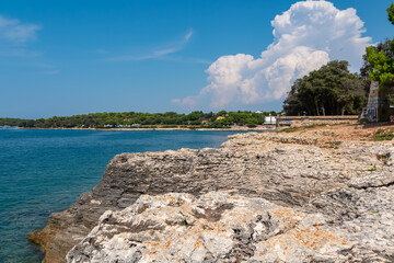 Rugged coastal landscape with rocky cliffs plunging into the crystal-clear Adriatic Mediterranean...