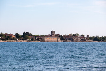 Fototapeta premium Scenic view of picturesque coastal town Dajla seen from shoreline of Karigador, Istria peninsula, Croatia, EU. Village is nestled along the waterfront of Adriatic Mediterranean sea. Summer vacation