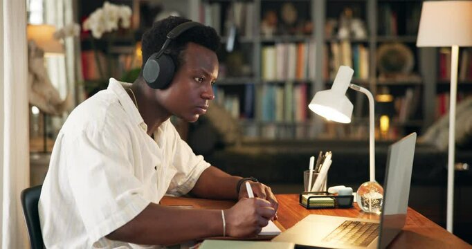 University, library and man with headphones on laptop for online learning, studying and education. School, academy and person listen to music on computer for research, assignment or project on campus