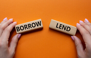 Lend or Borrow symbol. Concept word Lend or Borrow on wooden blocks. Businessman hand. Beautiful...