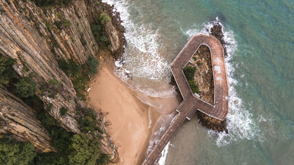 Observation deck overlooking the sea and lava rocks captured by a drone. A stunning spot for nature lovers.