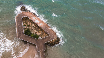 Wooden observation deck above the sea. A serene spot to enjoy coastal views.