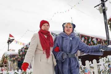 Nature, smile and senior friends hugging for support, bonding or care in outdoor Christmas market ....
