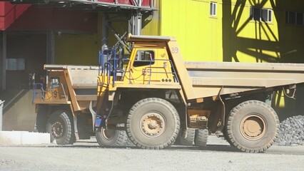 A Heavy Duty Dump Truck Handling Bulk Materials at a Busy Construction Site Environment. Stock Clip