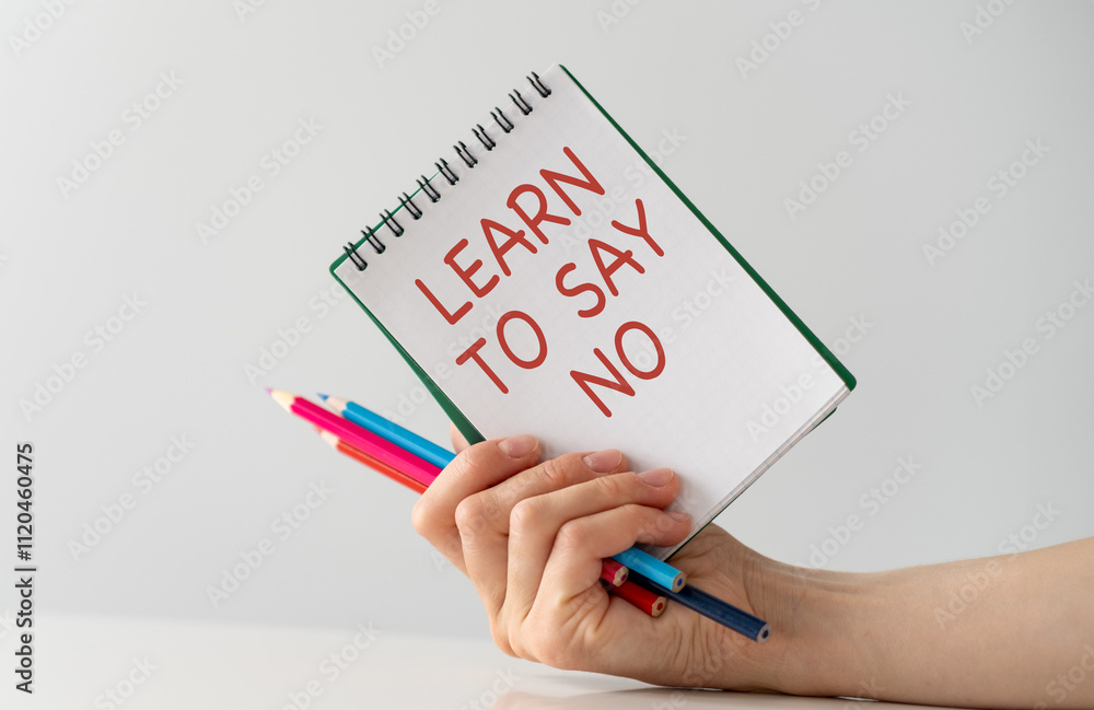 Poster a person is holding a notebook with the words learn to say no written on it