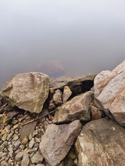 rocky river bank, calm water
