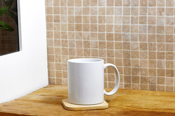 white coffee mug , white porcelain mug mock up on wood table near window