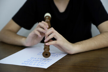  Young person studying music sheet. Recorder music class. © Acento Creativo