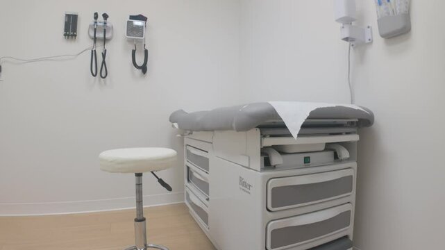 Victoria, British Columbia, Canada. December 06, 2024: Slow motion view of an empty medical clinic bed with equipment on the wall