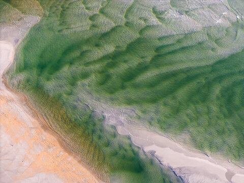 Aerial drone view of sand formations left by the storm. The verity of color make a great background. Taken from 300 ft. at Wrightsville, Beach, NC