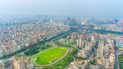 Obraz premium Aerial view of a city with green spaces and urban areas.