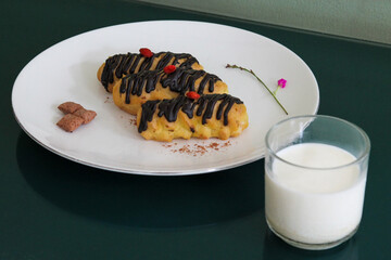 Chocolate Eclairs Served with Milk Side View on Dark Background Indonesian Dessert Asian Food