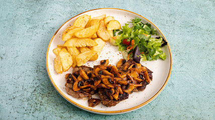 Roasted potatoes and mushrooms with herb on plate