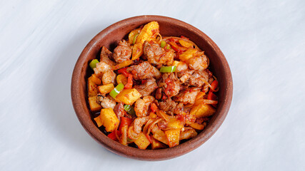 Roasted beef with cherry tomatoes and potatoes in pot