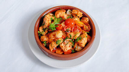 Roasted chicken with cherry tomatoes in pot