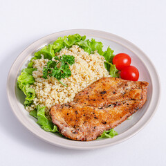 Schnitzel and bulgur on plate