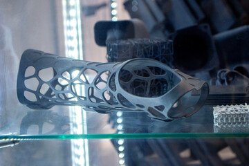 Hand splint corset prosthesis printed on 3D printer from molten black plastic powder. Medical...