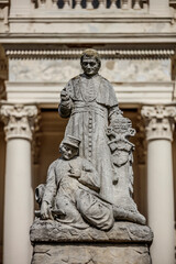 Large stone monument depicts a bishop and a soldier, likely a memorial.  Detailed carving on a pedestal.