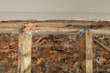 Deck Ledger Board Incorrectly Installed over Wood Siding has led to Extensive Dry Rot and Damage