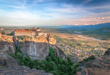 Obraz premium The Nunnery of St. Stephen, an Eastern Orthodox monastery in Meteora, Thessaly, central Greece, with Kalambaka in the background