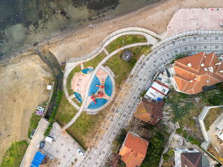 Istanbul Turkey Beykoz Poyrazkoy High-Angle View of Coastal Park and Residential Area. An aerial perspective of a coastal park with a playground, surrounded by walkways and residential buildings.