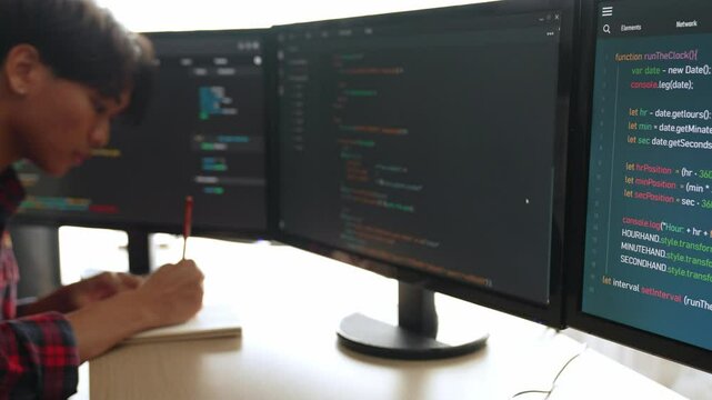 Slow motion back end software developer engineer for computer programming working together on debugging writing computing code, solving complex algorithms display on monitor in office. Burgeoning
