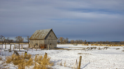 An old rustic barn in a field during winter