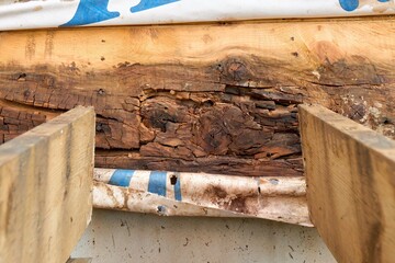 Removed Deck Ledger Board Reveals Dry Rotten Rim Joist Board with Extensive Damage on House
