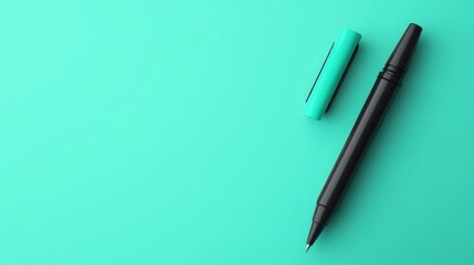 Black Pen and Teal Cap on Aqua Background