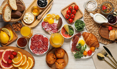 Different tasty food served for brunch on white wooden table, flat lay