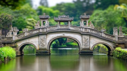 Fototapeta premium Ornate Stone Bridge Arching Over Calm Water In Lush Garden