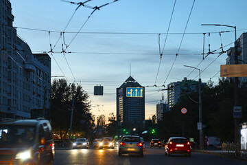 Cityscape with road traffic and street lights in evening