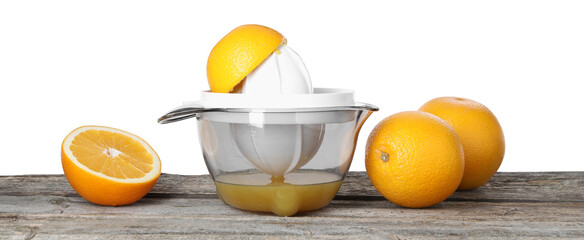 Plastic juicer and fresh oranges on wooden table against white background