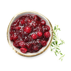 Tasty cranberry sauce in bowl and thyme isolated on white, top view