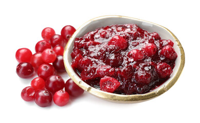 Tasty cranberry sauce in bowl and berries isolated on white