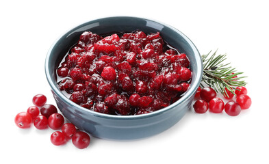 Tasty cranberry sauce in bowl, berries and fir branch isolated on white